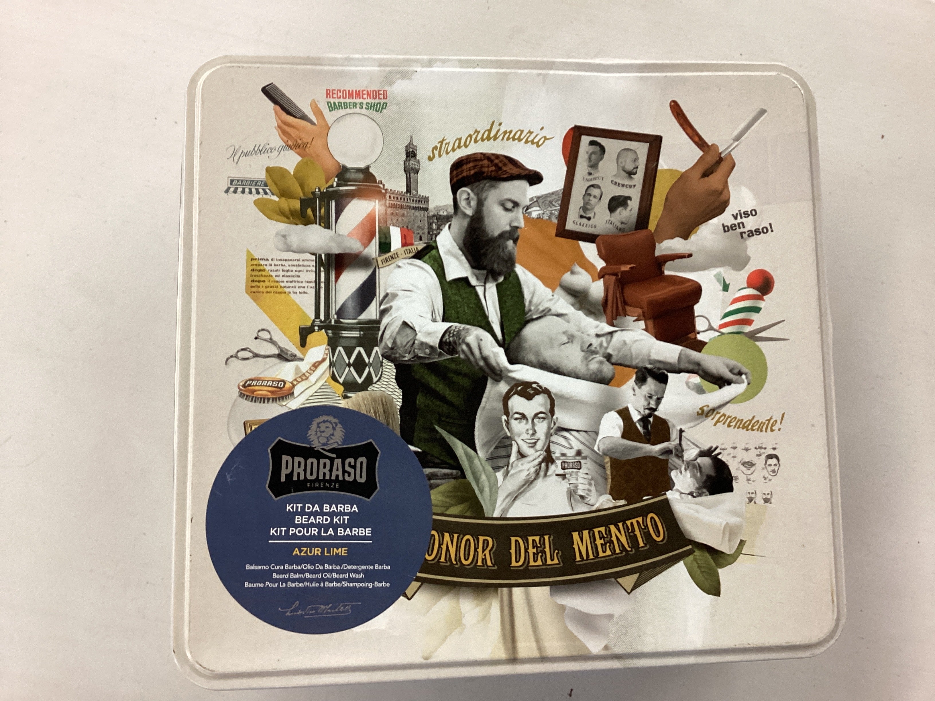 Barber-themed Proraso product packaging on a metallic surface