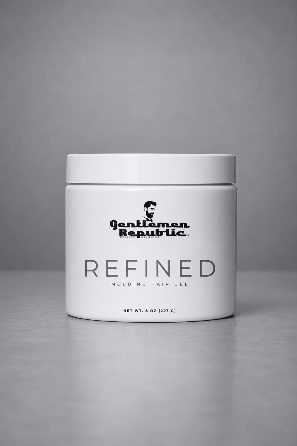 White jar of 'Gentleman Republic Refined' hair gel on a gray background