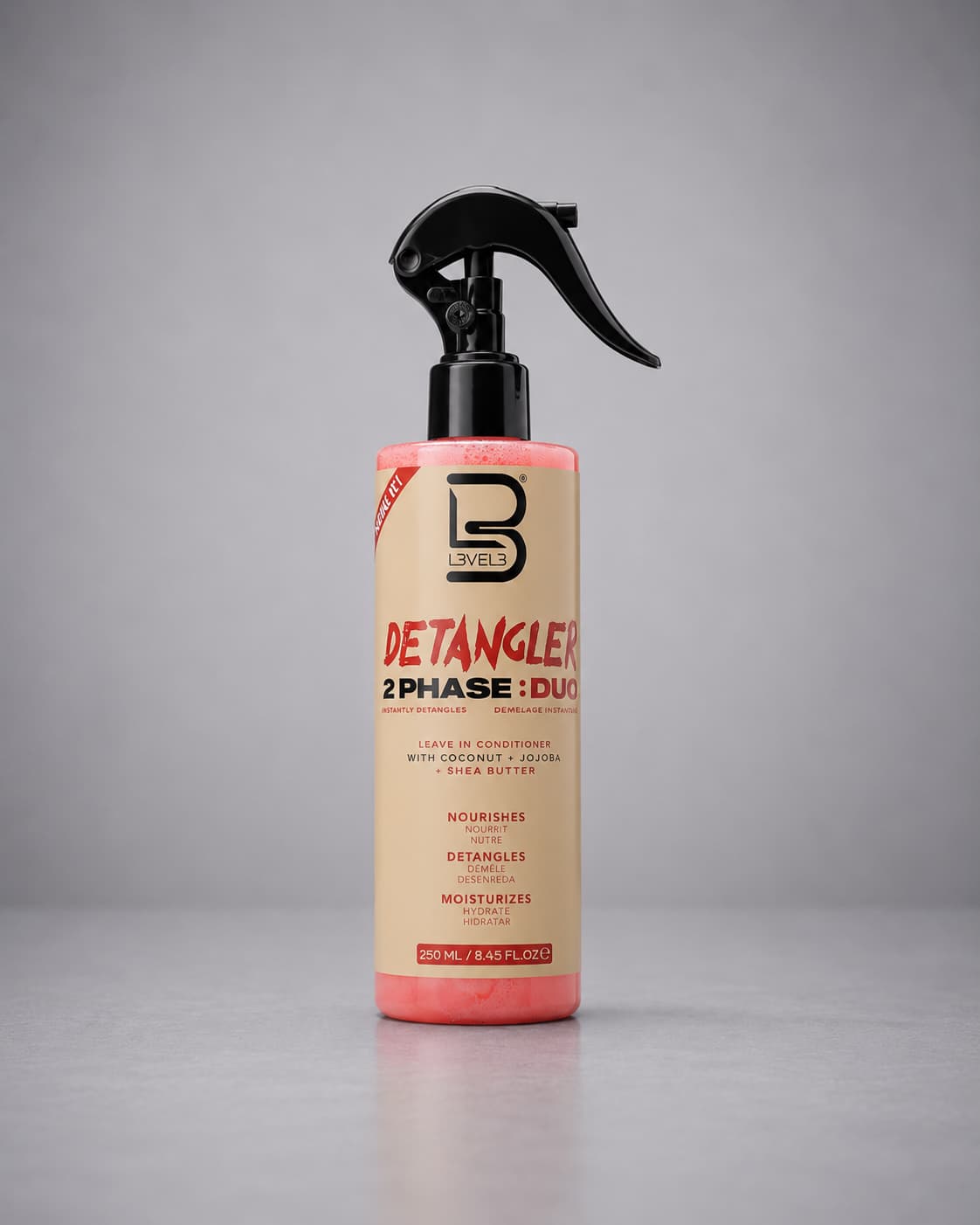 Detangler spray bottle with black nozzle on a white background