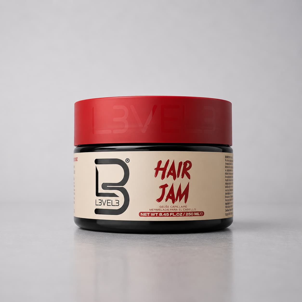 Jar of Level 3 Hair Jam with red lid on a gray background