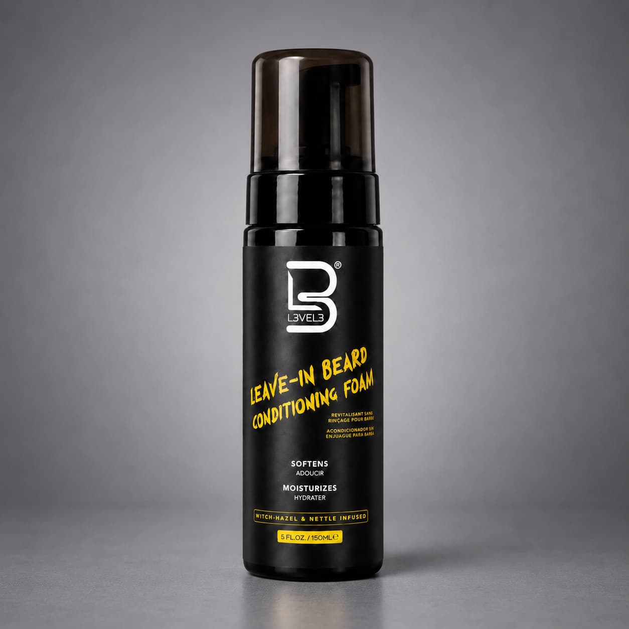 Black bottle of leave-in beard conditioning foam with yellow text on a gray background