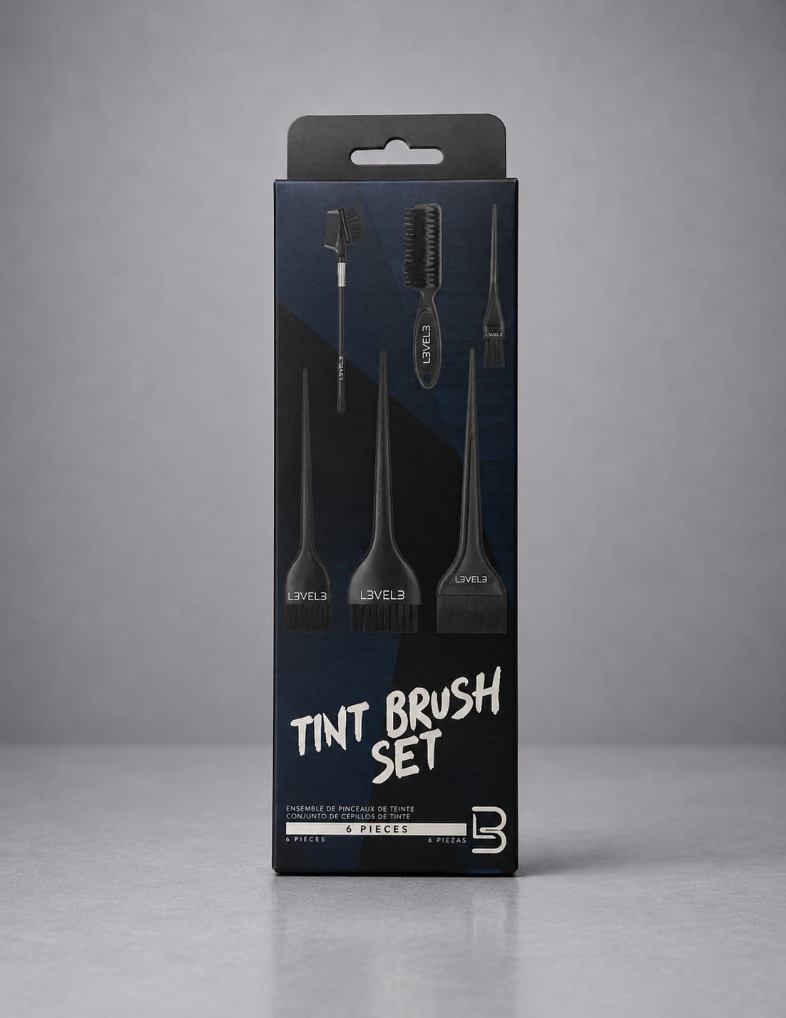 Packaging of a tint brush set with black brushes on a gray background