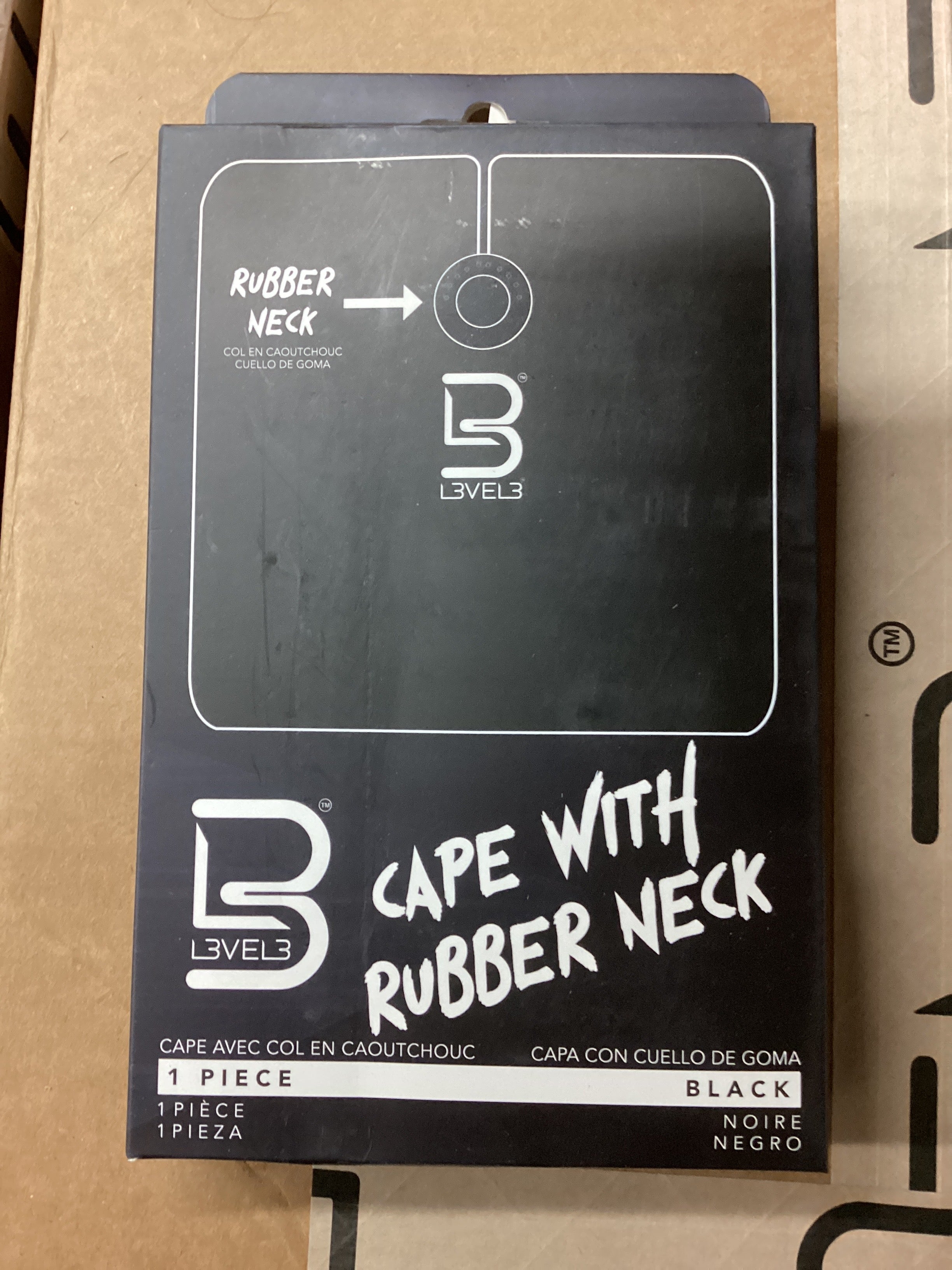 Cape with rubber neck packaging on a cardboard surface