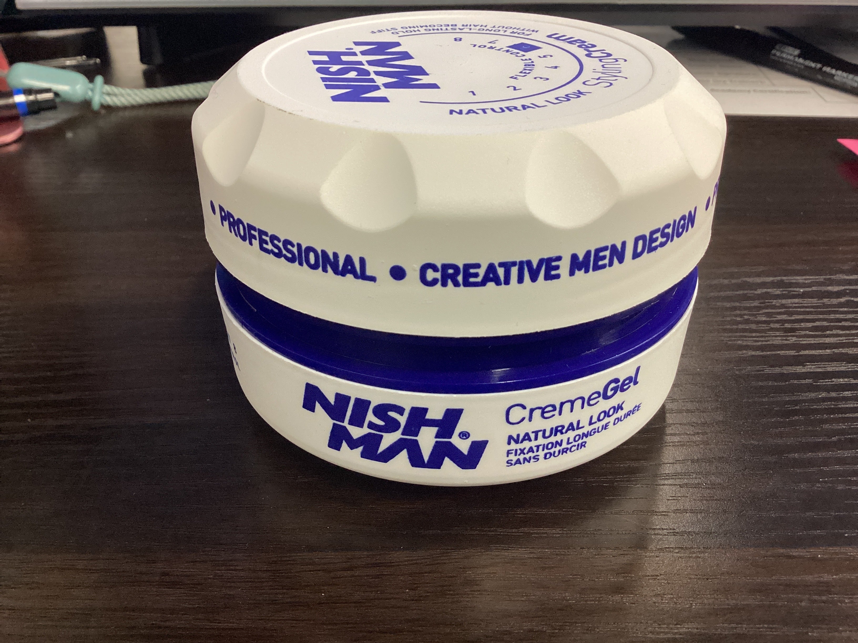 Nish Man Creme Gel jar on a wooden surface