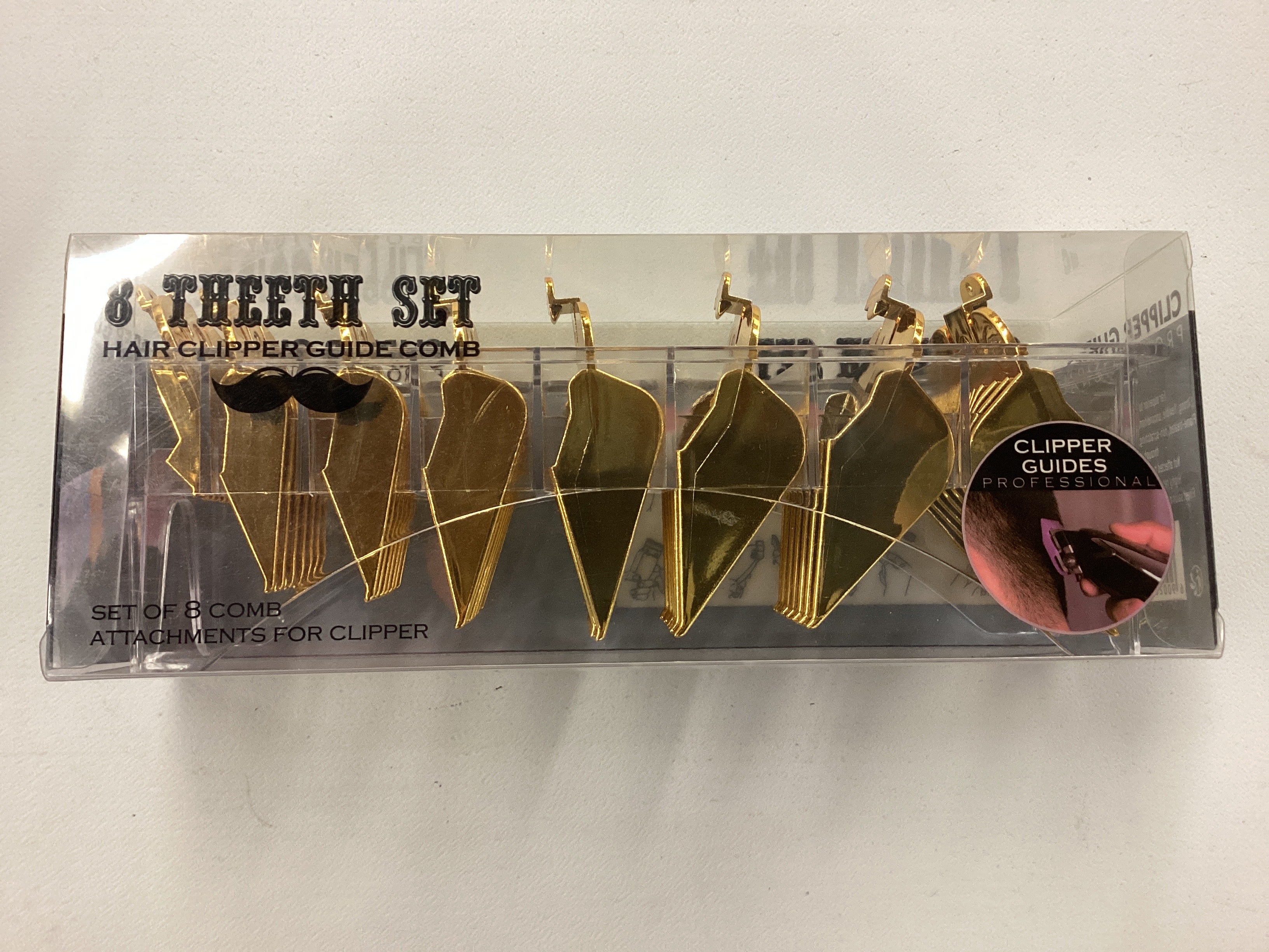 Set of gold hair clipper guide combs in packaging on a white background